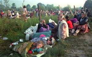 FILE -- In this July 14, 1995 file photo, refugees from the overrun U.N. safe haven enclave of Srebrenica who had spent the night outdoors, gather outside the U.N. base at Tuzla airport. Israeli police have arrested a former Bosnian Serb soldier suspected of playing a role in the 1995 massacre of Bosnian Muslims at Srebrenica, Israel's Justice Ministry said Tuesday, Jan. 18, 2011. (AP Photo/Darko Bandic, File)